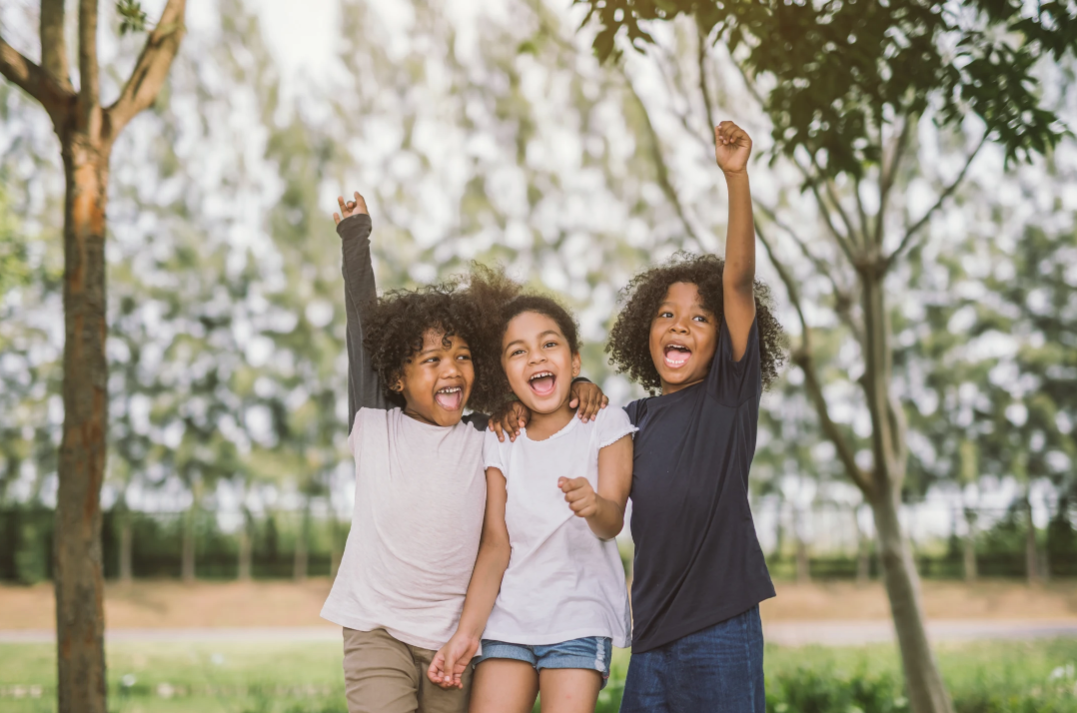 children playing happily in a yard