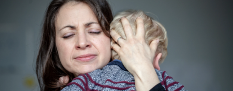 mother clutches child with separation anxiety