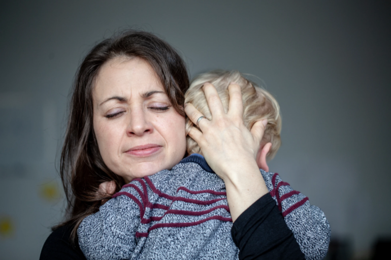 mother clutches child with separation anxiety
